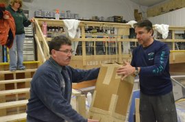 Stewart Workman (left) and Dave Carraro unload a box of gear from Tuna.com under Alice Workman’s watchful attention. PICTURE with STEPHEN RAPPAPORT