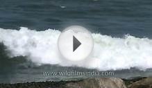 Small fishing boats float through waves of Arabian sea